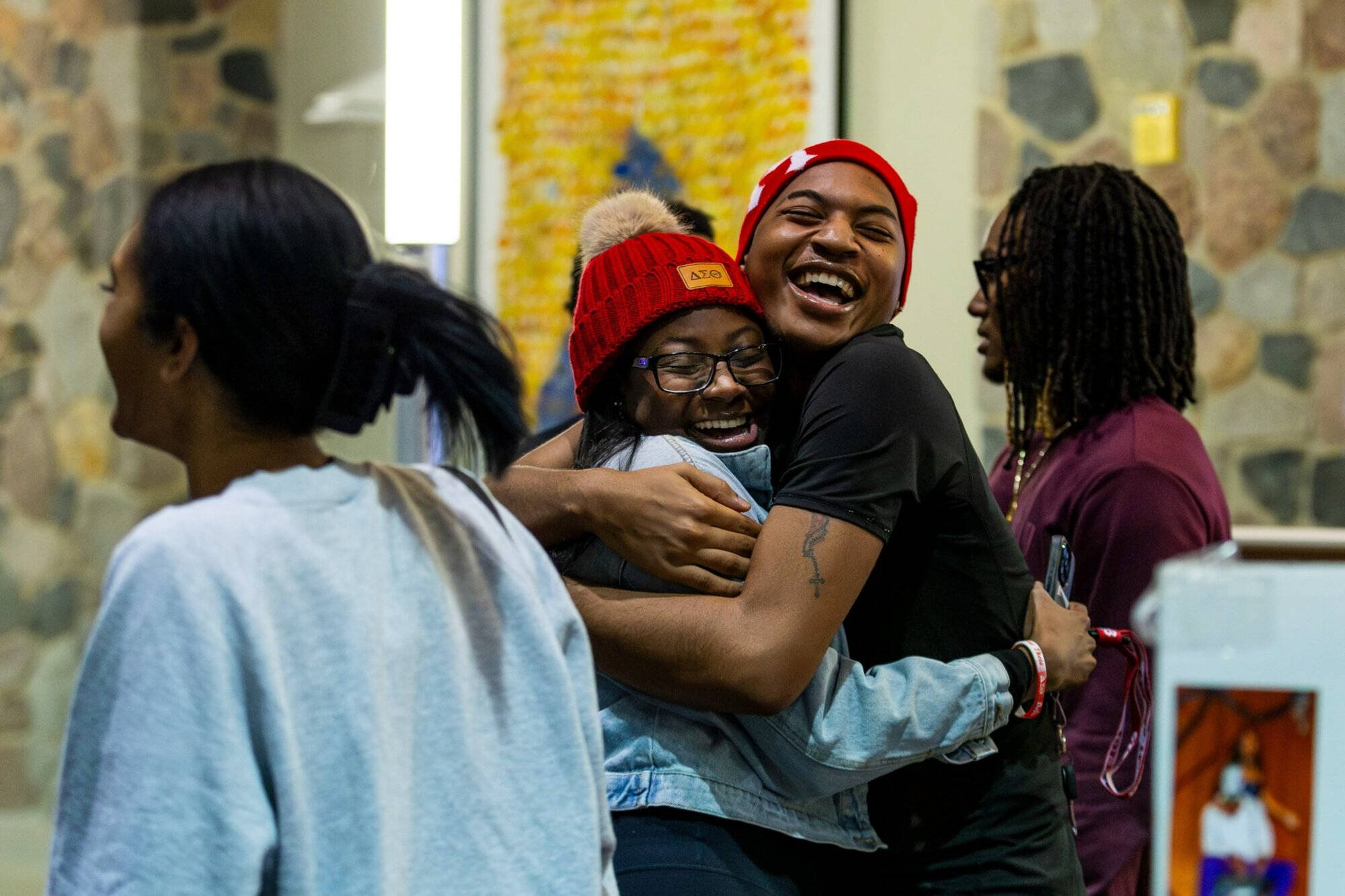 Two students hugging in the Mary Idema Pew Library atrium